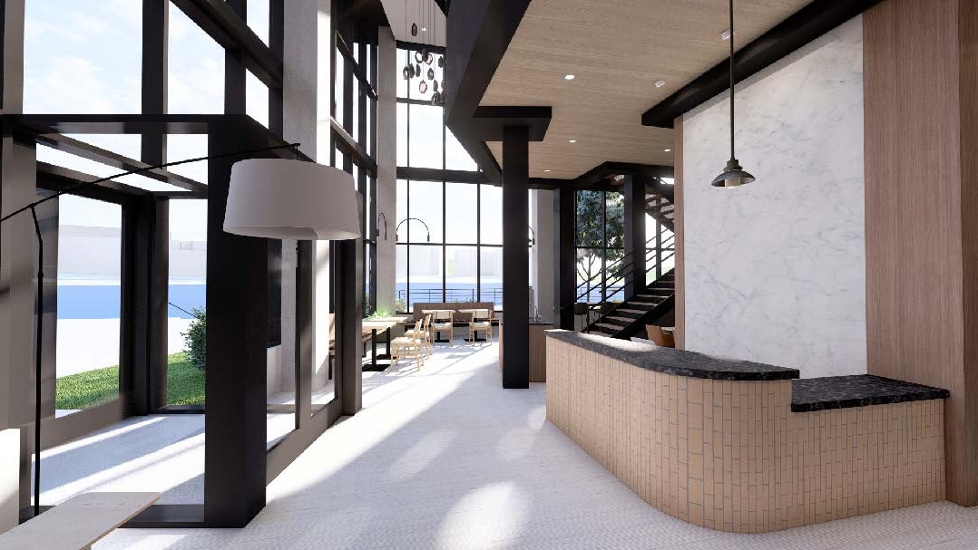 Lobby with floor to ceiling windows, and a welcome desk with tan vertical tile facade.